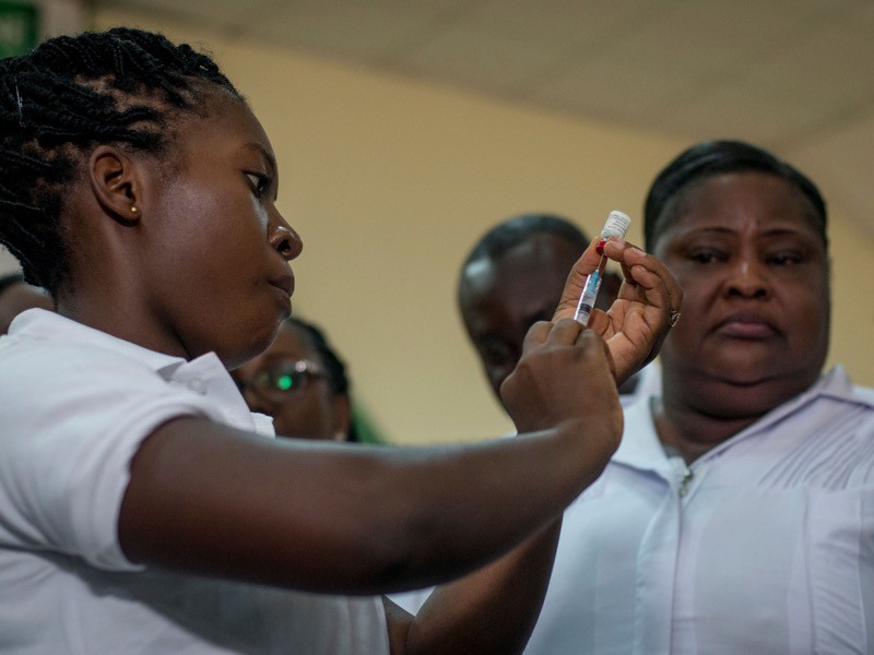 A nurse of Ewin Polyclinic takes Malaria vaccine Mosquirix, Ghana.