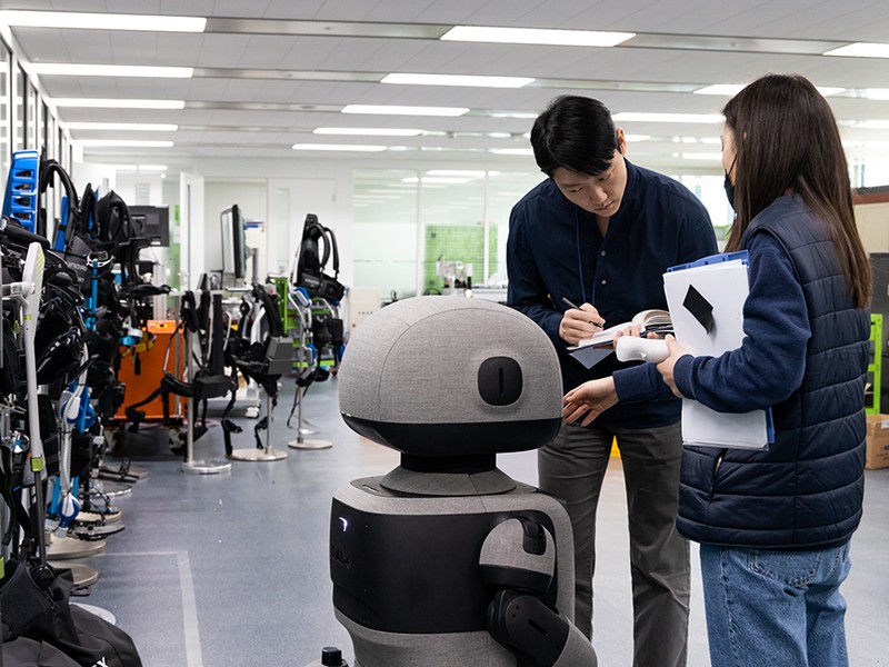 Engineers inspect a DAL-e humanoid robot at the Hyundai robotics laboratory in Uiwang, SK.