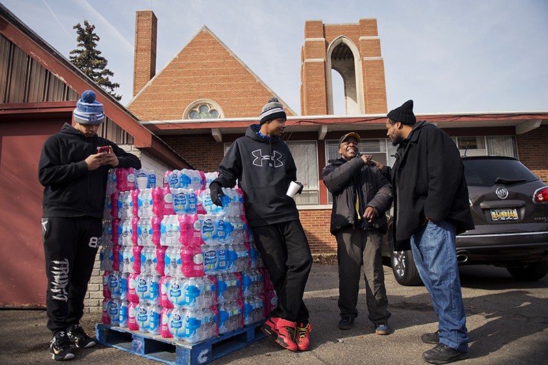 People distributing water at the St. Mark Baptist Church in Flint, Michigan, US