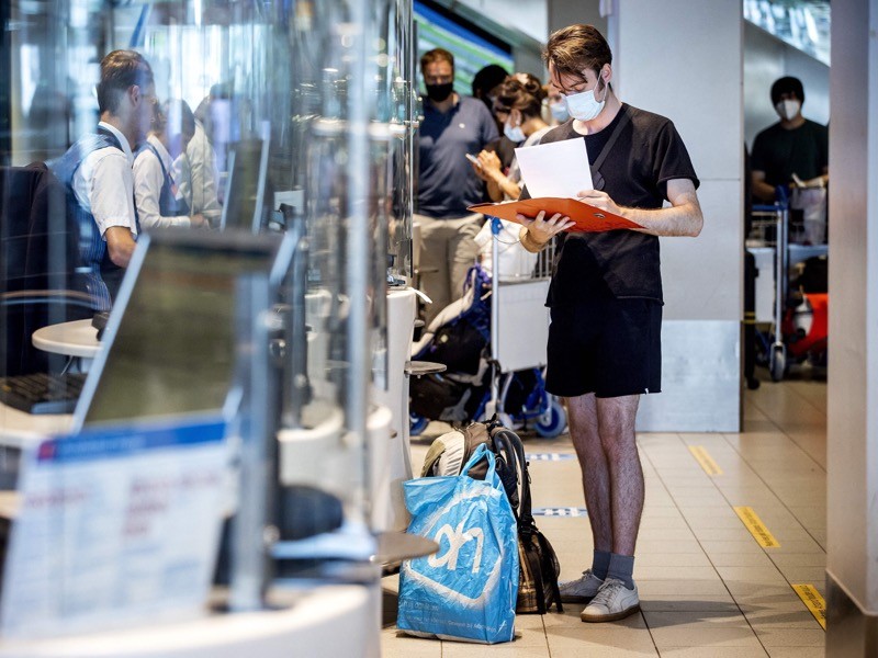 A traveller checks in at a KLM counter at Amsterdam's Schiphol Airport.