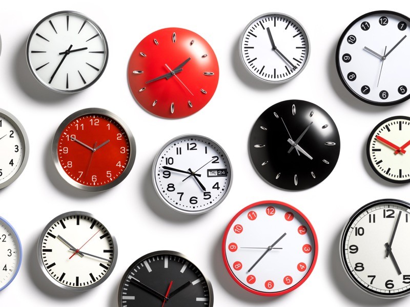 A selection of wall clocks showing different times.