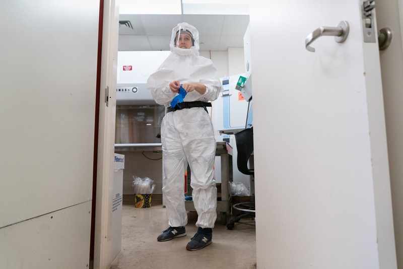 Lisa Gralinski dressed in a Tyvek body suit at a research lab