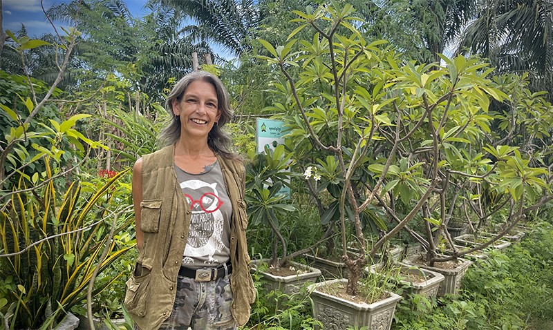 Photograph of Kit Magellan surrounded by vegetation