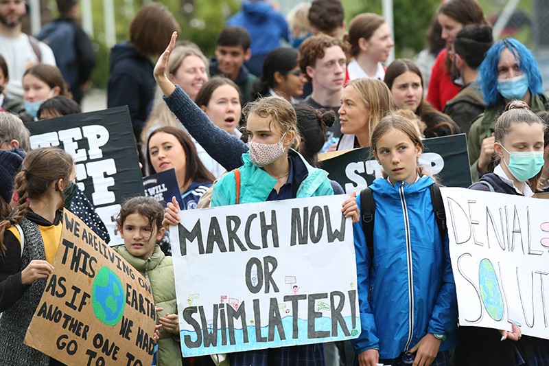 Youth climate change protesters in Prince Alfred Park hold signs during a School Strike for Climate protest in Sydney, Australia