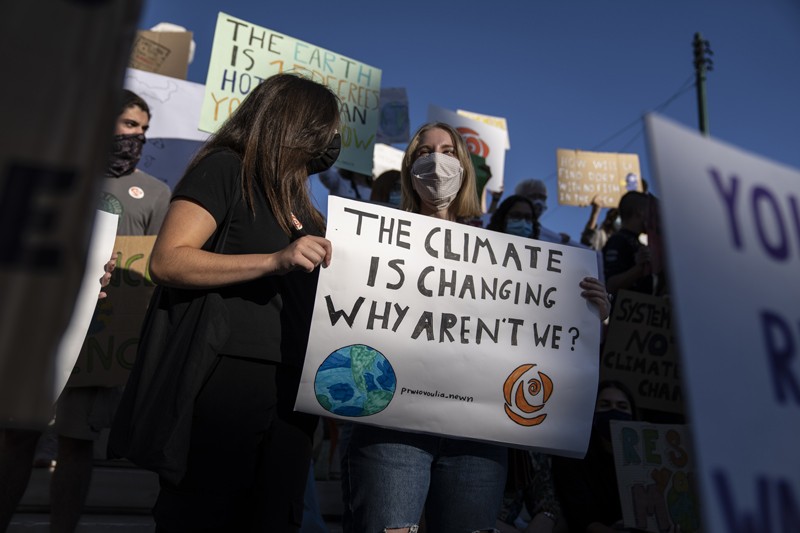 Students hold up a climate protest banner during a rally in Athens