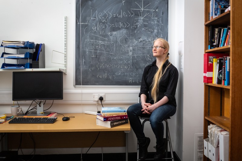 Portrait of Sofia Qvarfort, quantum physicist working on optomechanics and gravity sensing in her office at UCL.