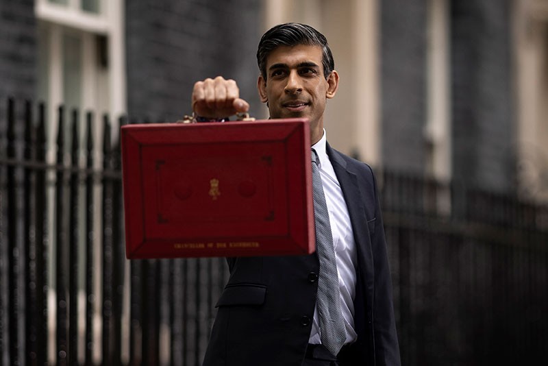 Chancellor of the Exchequer Rishi Sunak holds the budget box as he departs 11 Downing Street in London, England.