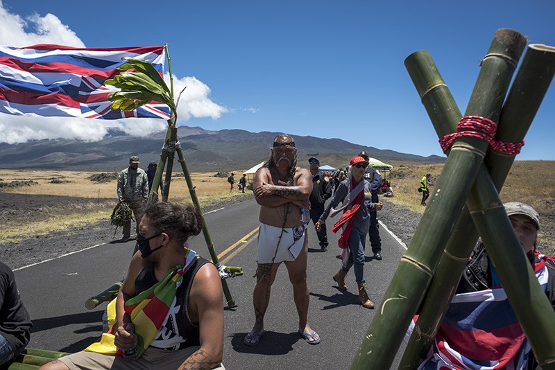 Hundreds of demonstrators gathered by the Maunakea Access Road in Hawaii to halt telescopes being built on sacred land.