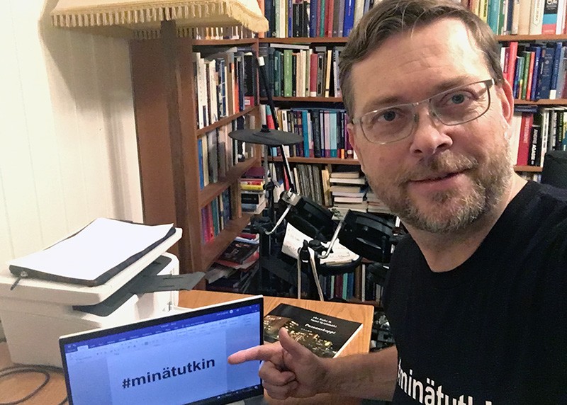 Sami Syrjämäki shows a Finnish hashtag on Twitter with his computer in his home office.