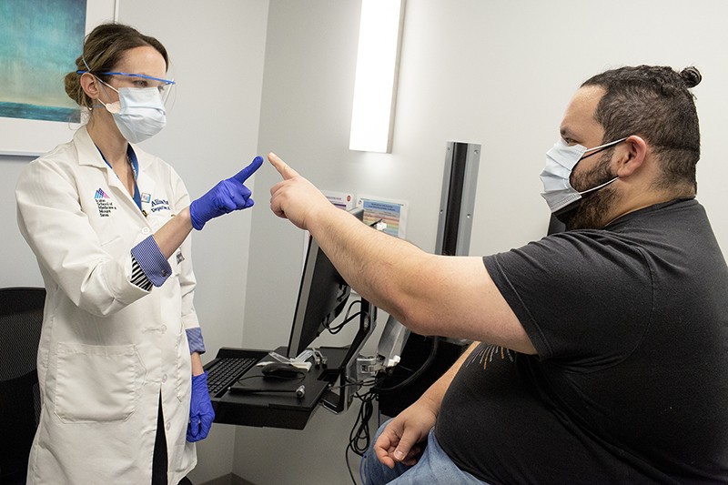 Allison Navis at Mount Sinai's Center for Post-COVID Care testing movement with a patient.