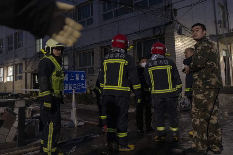 Firemen work at the site of an explosion at Beijing Jiaotong University in Beijing in 2018