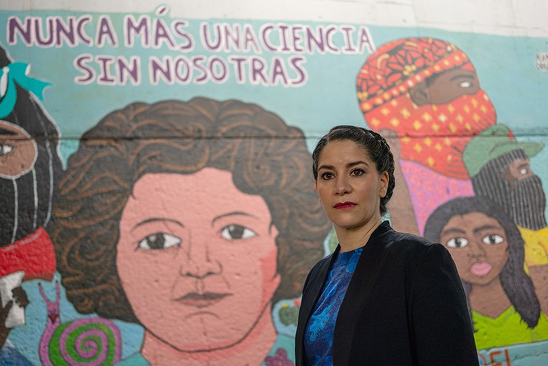 Vivette Garcia Deister in front of a mutual of diverse people at the National Autonomous University of Mexico, in Mexico City.