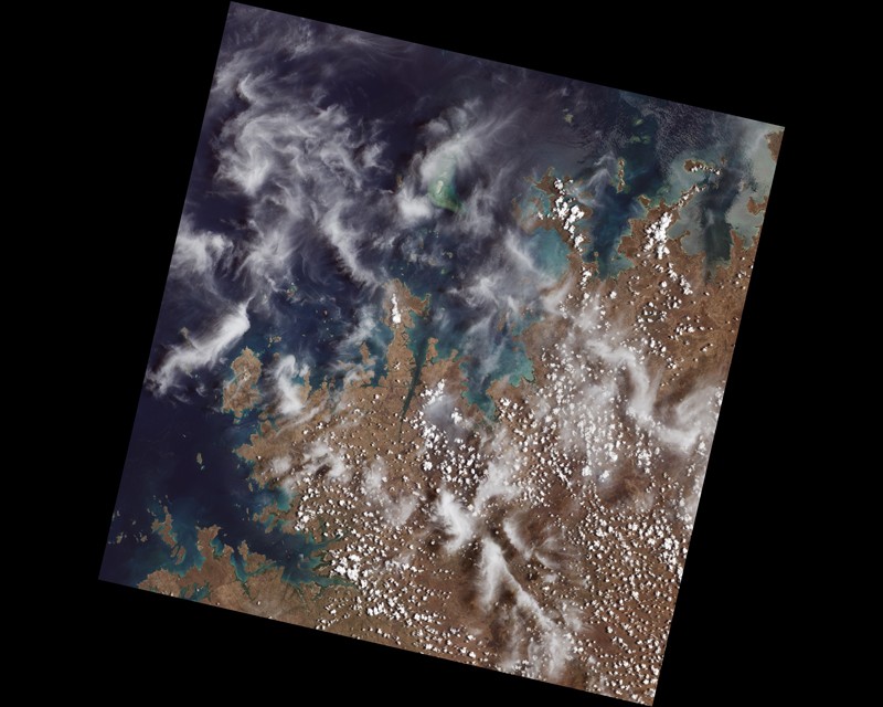 Satellite image of the coast of Australia showing mangrove forests around inlets and bays