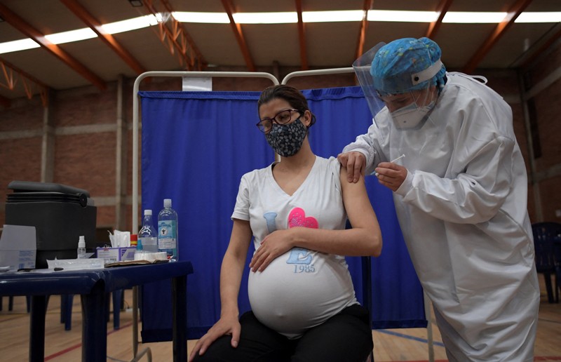 A pregnant woman receives a dose of the Pfizer-BioNTech vaccine
