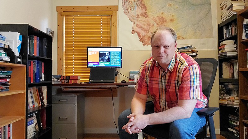 Leif Fredrickson sitting near his desk in his home office in December 2021.