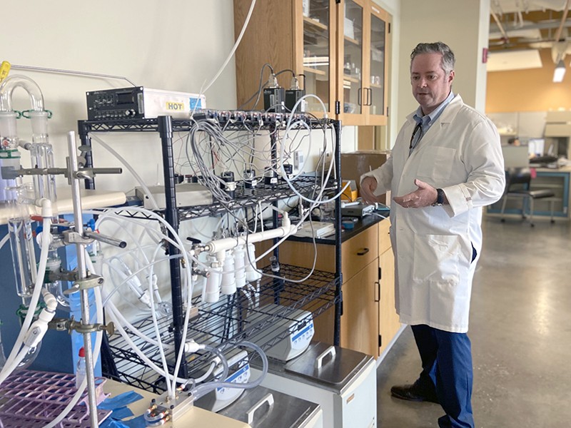 Roger Tipton at his university lab, with a sensor-development station for detecting harmful gases in the air.