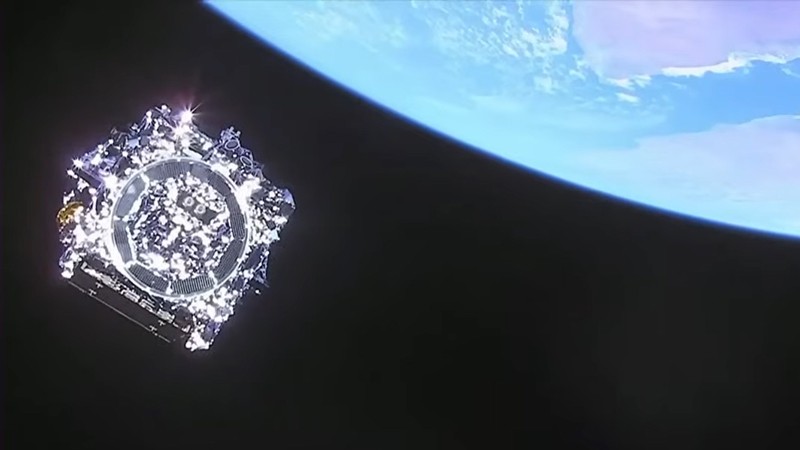 View of the James Webb Space Telescope drifting past Earth into deep space after releasing from the rocket that launched it