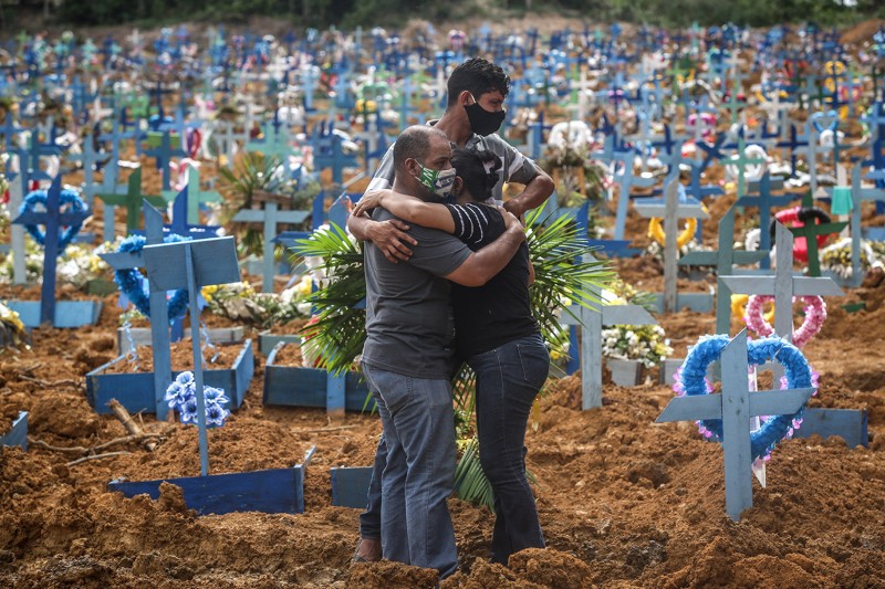 Relatives of a deceased person mourn during a mass burial of COVID-19 victims at the Parque Taruma cemetery in Manaus, Brazil.