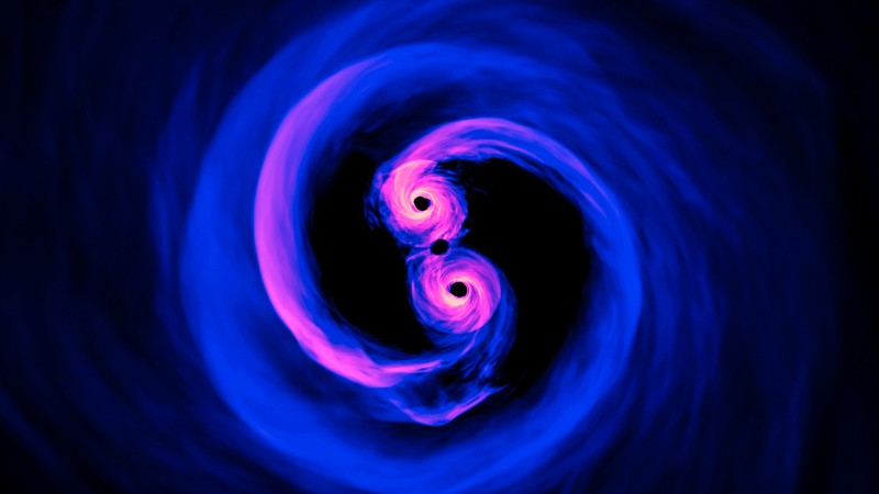 Supercomputer simulation of two supermassive black holes orbiting as a binary pair, close to the point of merging.