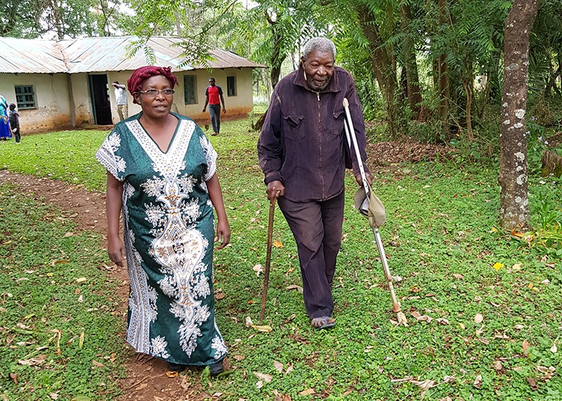 Rose Okoyo Opiyo walks with her 96 year old uncle in 2019, discussing how a light walk and healthy eating are vital in old age.