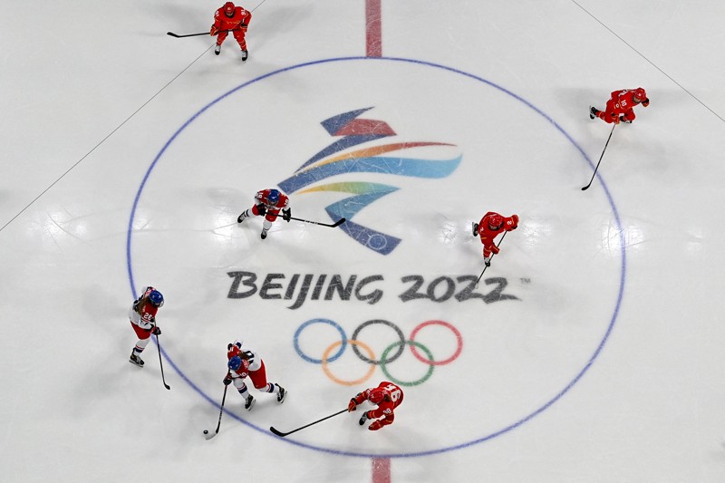 Bird's eye view of an ice hockey match showing the Beijing 2022 olympics logo