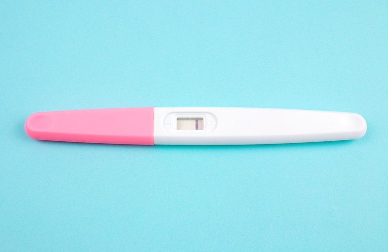 Negative pregnancy test on a blue background
