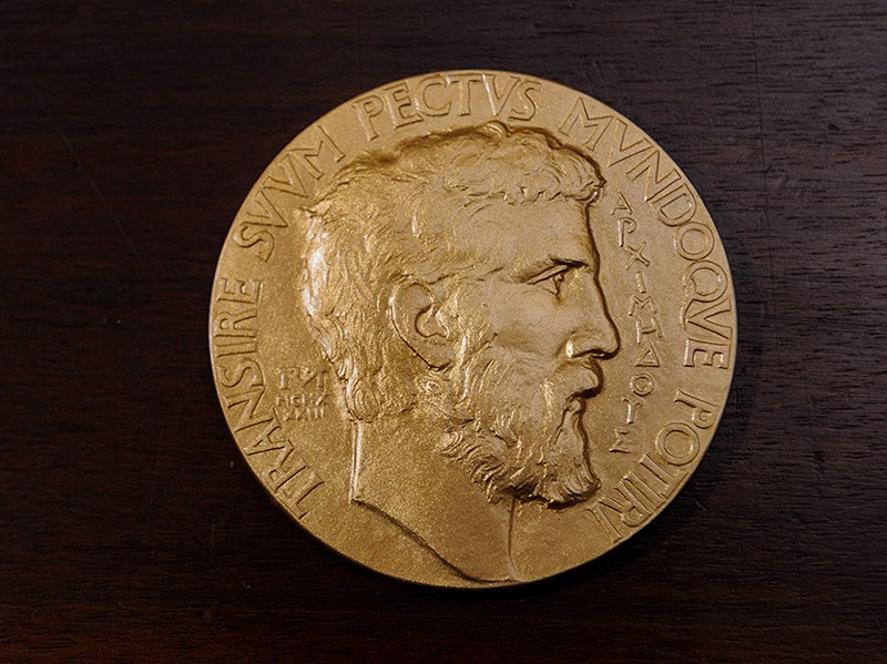 The Fields Medal, solid gold: the obverse represents the profile of Archimedes with his motto.