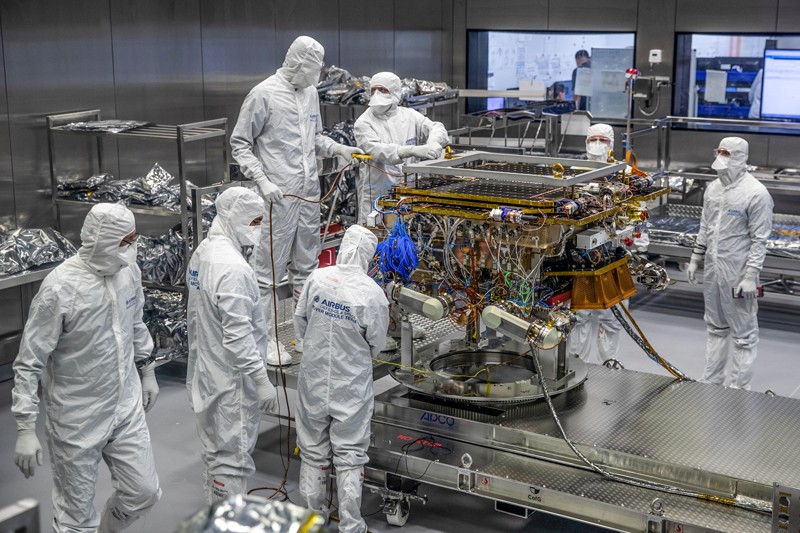 Airbus engineers in white overalls prepare the ExoMars 2020 rover Rosalind Franklin for removal