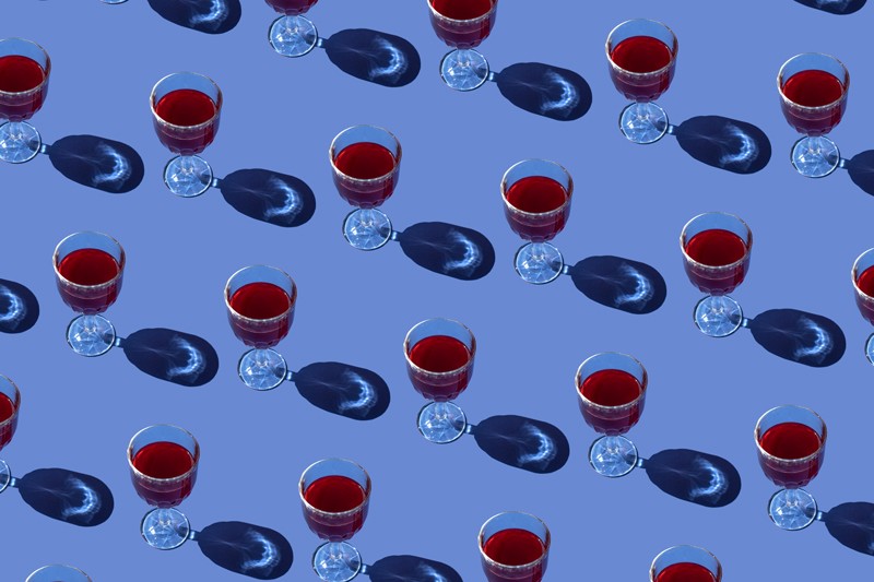 Repeated pattern of wine glasses on a blue background