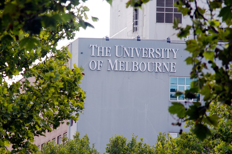 The University of Melbourne sign on the side of the building.