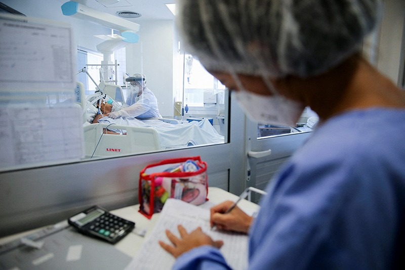 Medical workers care for a patient at the intensive care unit amid the outbreak of the COVID-19 disease in Porto Alegre, Brazil.