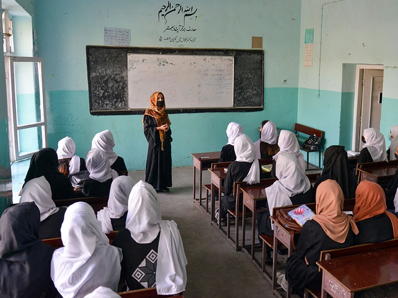 Girls attend a class after their school reopened in Kabul on March 23, 2022.