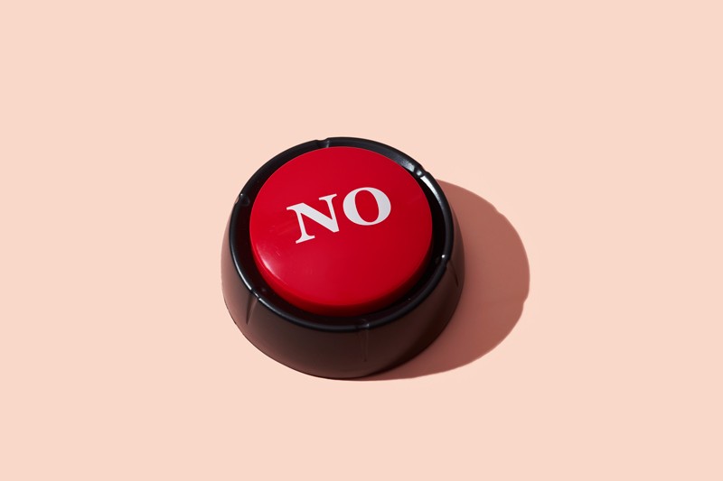 Red push button with the word 'no' on a pink background