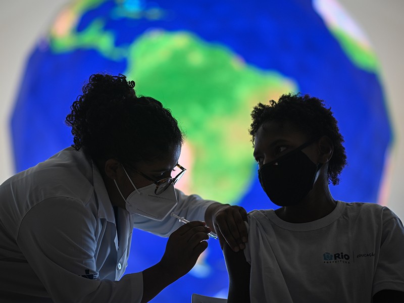 A healthcare worker administers a dose of the Pfizer-BioNTech Covid-19 vaccine to a child at the Museu do Amanha in Rio.
