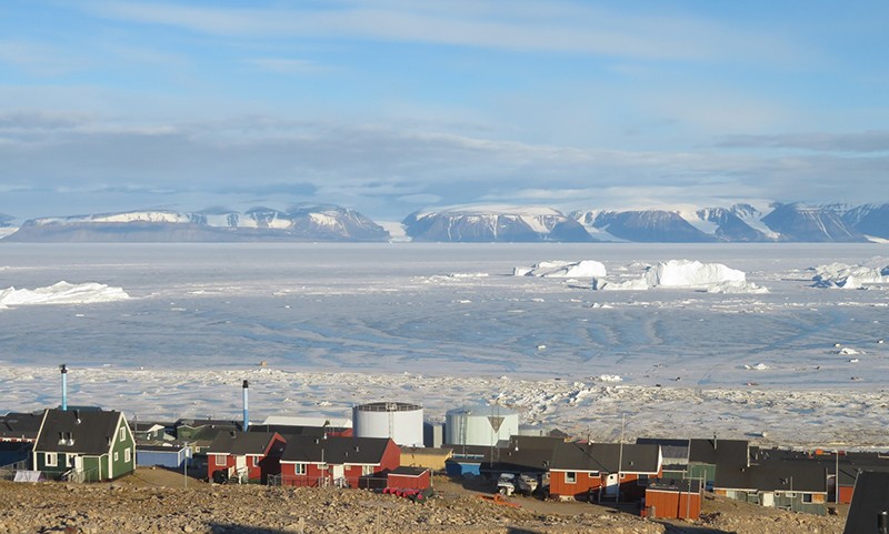 The town of Qaanaaq, Greenland, with the bay and ice formations in 2019.