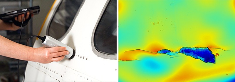 Human hand holding a sensor against the white exterior of an aeroplane, showing a crack and a dent in the 3D imaging.