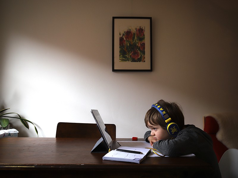 Six-year-old Kaya Atayman sits in front of his computer while homeschooling at his home in the Sydney suburb of Bondi.