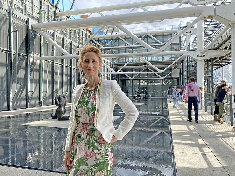 Nicole Boivin, a former director of one of the Max Planck Society’s research institutes, inside an atrium with art behind her.