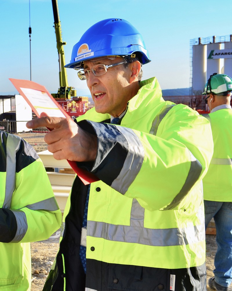 Bernard Bigot on an ITER worksite wearing safety equipment