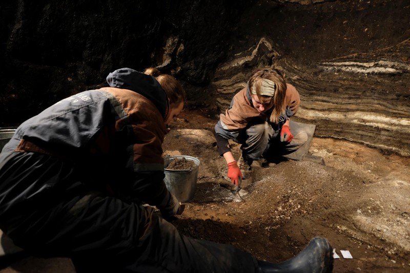 Archaeologists digging inside Denisova cave in Siberia