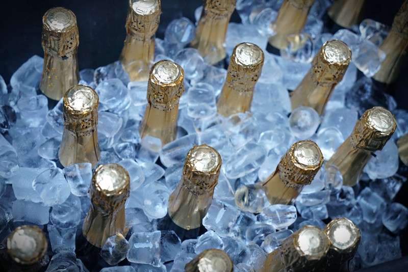 High angle view of champagne bottles sitting in a bucket of ice