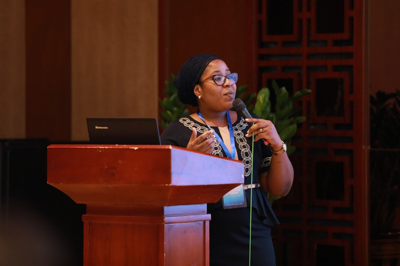Olusola Ashiru holding a microphone giving a talk