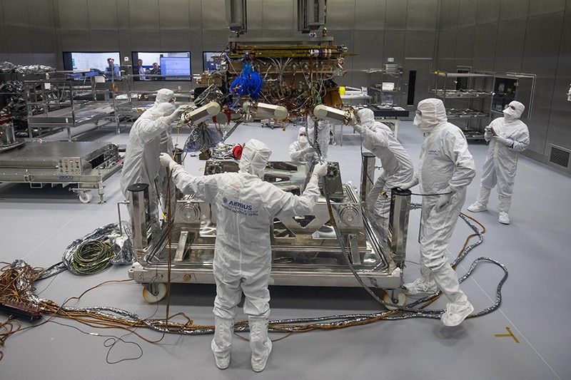 Engineers in clean-room suits work on the ExoMars rover at the Airbus facility in Stevenage UK