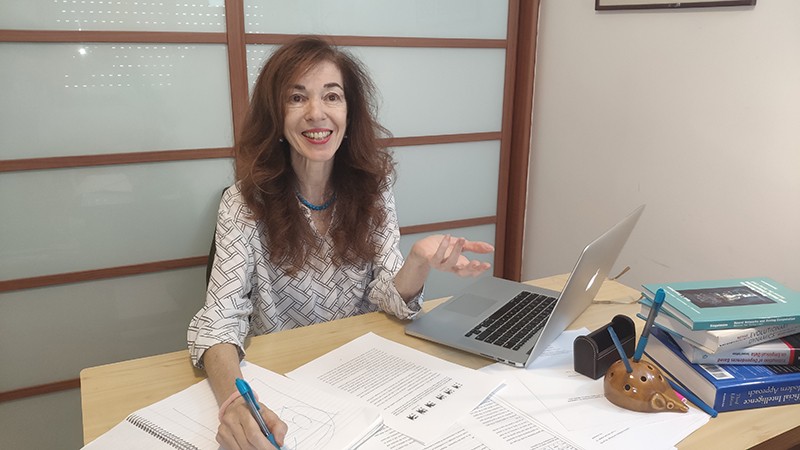 Hava Siegelmann sits at her desk with her laptop