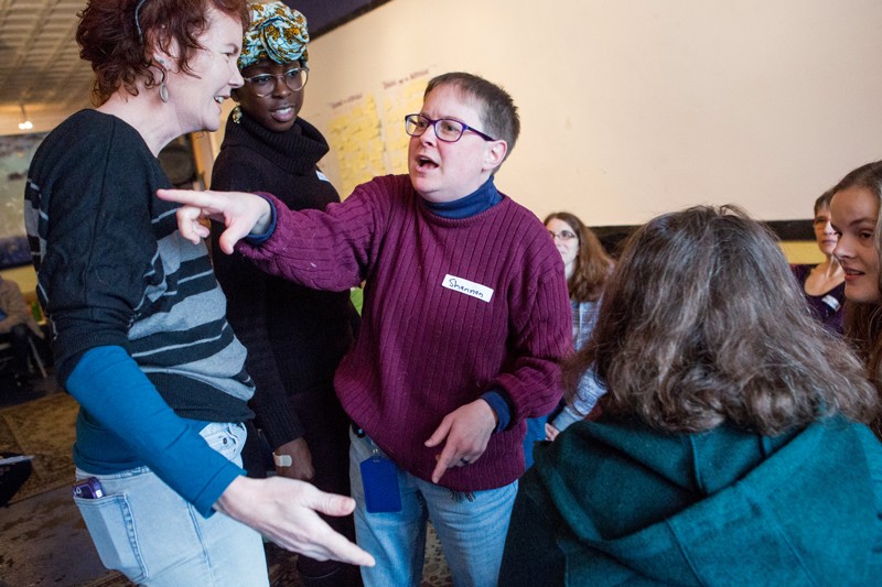Participants in a bystander intervention training session act out an improvisational scene