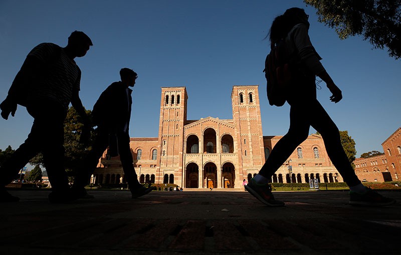 Students pass infront of Royce Hall on the campus of the University of California, Los Angeles (UCLA)