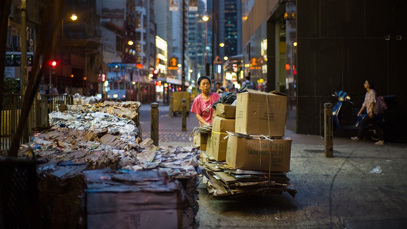 A woman pushes a trolley load of used cardboard to a recycling collection outlet in Hong Kong in 2018.