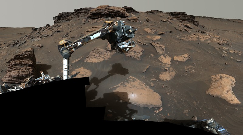 The robotic arm of the Perseverance rover working on a rocky outcrop called “Skinner Ridge” in Mars' Jezero Crater