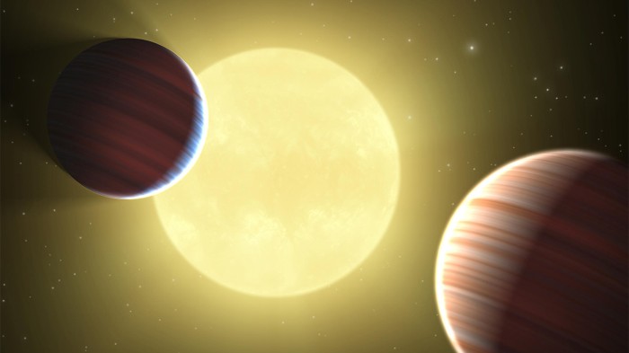 Illustration showing two Saturn-sized planets crossing in front of their star, Kepler-9.