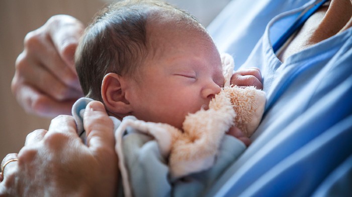 A premature baby being cared for by a nurse